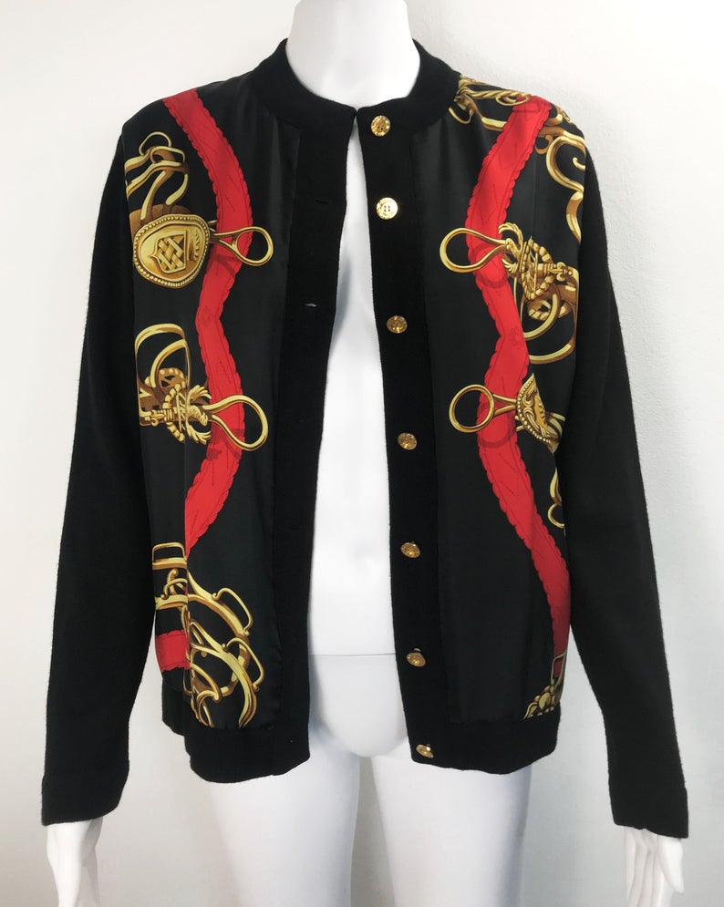 FRUIT Vintage Hermes classic in near mint condition, this cardigan is a beautiful piece of vintage Hermes history! It features an equestrian inspired silk scarf print at the front, full wool rear and gold logo buttons.