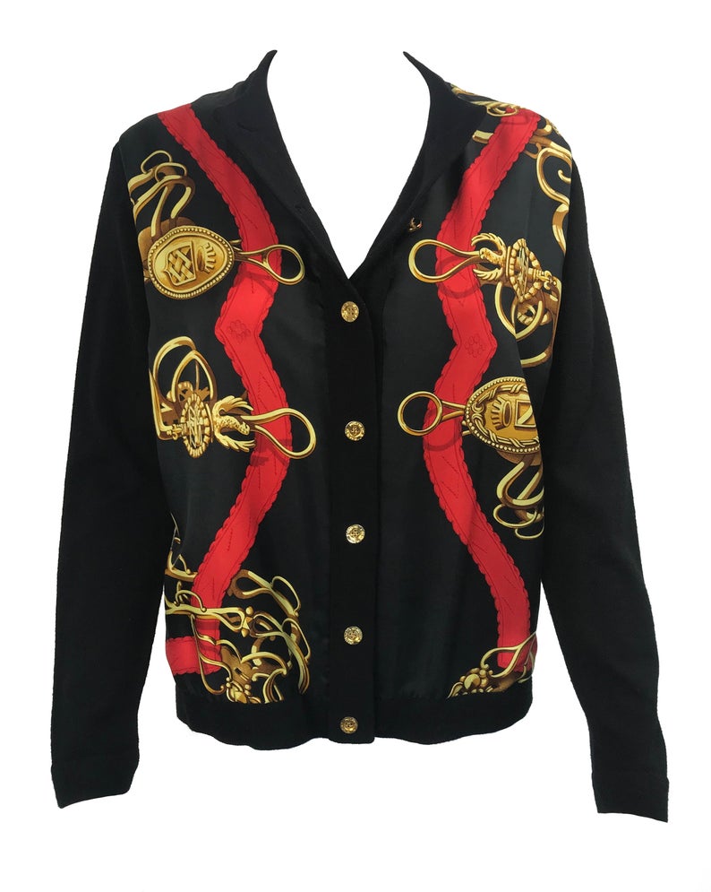 FRUIT Vintage Hermes classic in near mint condition, this cardigan is a beautiful piece of vintage Hermes history! It features an equestrian inspired silk scarf print at the front, full wool rear and gold logo buttons.