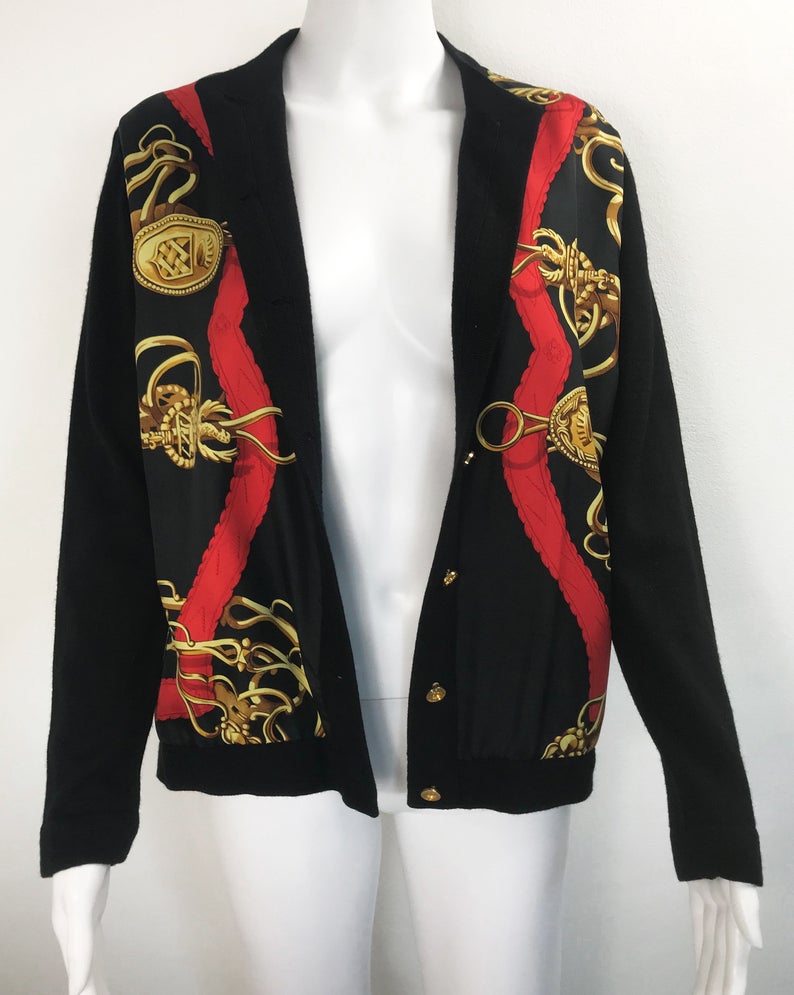 FRUIT Vintage Hermes classic in near mint condition, this cardigan is a beautiful piece of vintage Hermes history! It features an equestrian inspired silk scarf print at the front, full wool rear and gold logo buttons.