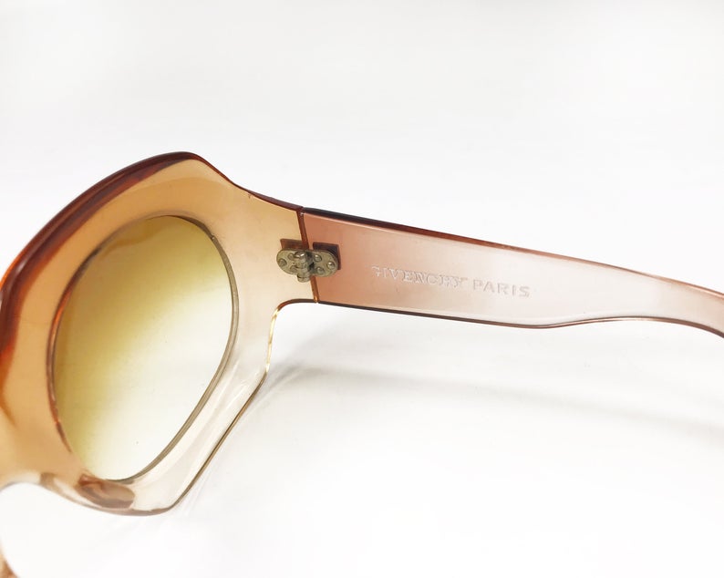 Fruit Vintage Givenchy Paris oversized vintage sunglasses dating to the 1970s. Comes with original suede case. Hand made, they feature Givenchy G logos on each arm and brown ombre lenses.