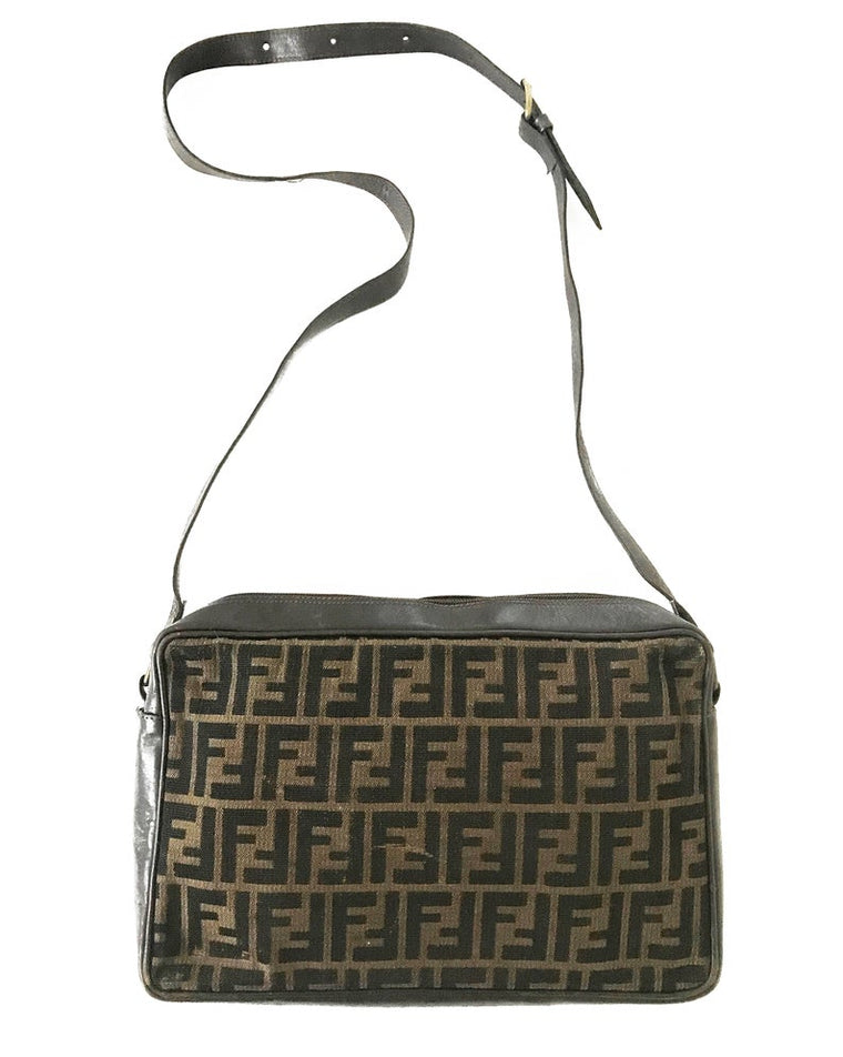 FRUIT Vintage Fendi Zucca cross body satchel handbag dating to the 1980s. It features the classic Fendi Zucca monogram canvas, front embossed logo, top zipper closure and long adjustable cross body strap bag.