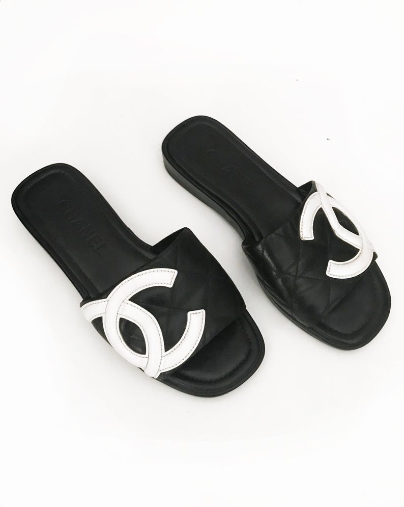 Fruit Vintage black Chanel logo slides with classic Chanel quilted leather with large CC monogram logos to the outer sides of each shoe.