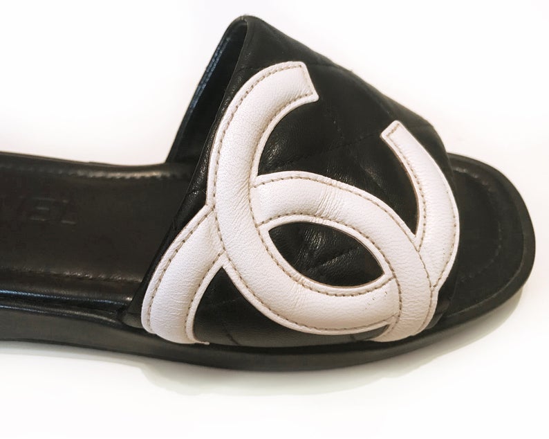 Fruit Vintage black Chanel logo slides with classic Chanel quilted leather with large CC monogram logos to the outer sides of each shoe.