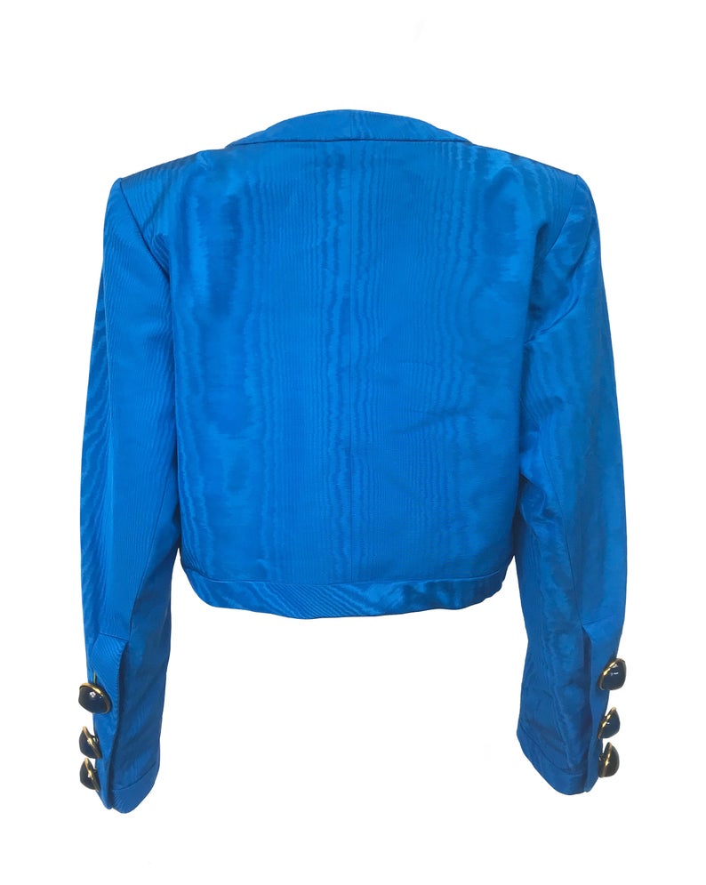 FRUIT Vintage Yves Saint Laurent Rive Gauche turquoise blue crop jacket dating to the 1980s. In near mint condition, this amazing piece features bright green lining and very large blue glass features buttons to each cuff.