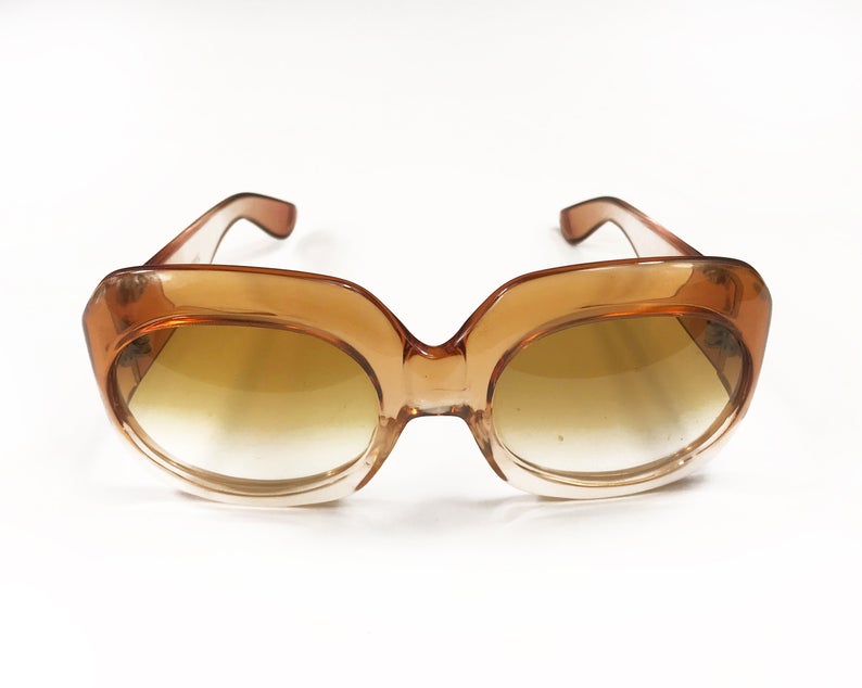 Fruit Vintage Givenchy Paris oversized vintage sunglasses dating to the 1970s. Comes with original suede case. Hand made, they feature Givenchy G logos on each arm and brown ombre lenses.