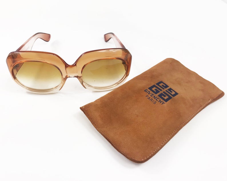 Fruit Vintage Givenchy Paris oversized vintage sunglasses dating to the 1970s. Comes with original suede case. Hand made, they feature Givenchy G logos on each arm and brown ombre lenses.