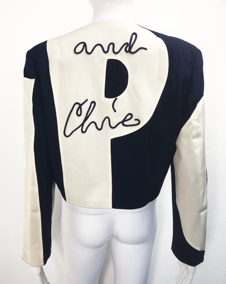 FRUIT Vintage rare and collectable Moschino Cheap & Chic logo slogan jacket dating to the 1990s. Cut for a cropped, boxy fit, it features a large, graphic, block letter design of the words 'CHEAP' with 'and Chic' embroidered at the rear.