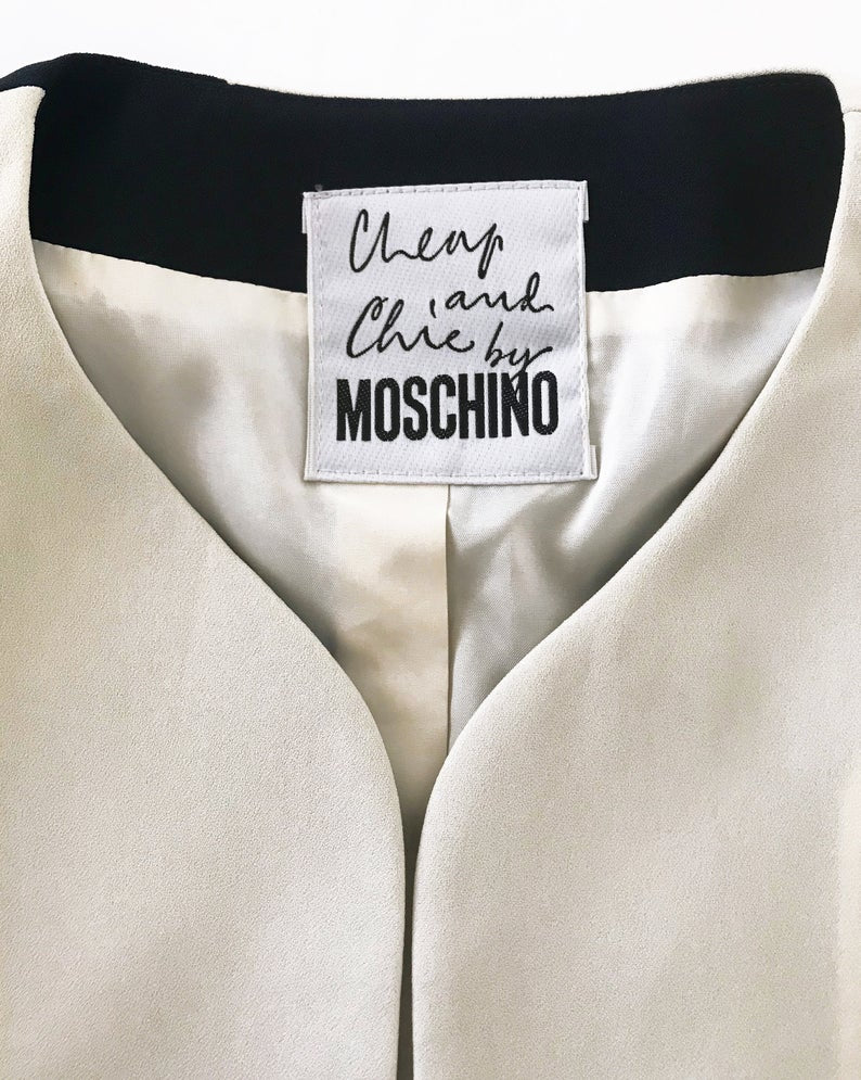 FRUIT Vintage rare and collectable Moschino Cheap & Chic logo slogan jacket dating to the 1990s. Cut for a cropped, boxy fit, it features a large, graphic, block letter design of the words 'CHEAP' with 'and Chic' embroidered at the rear.