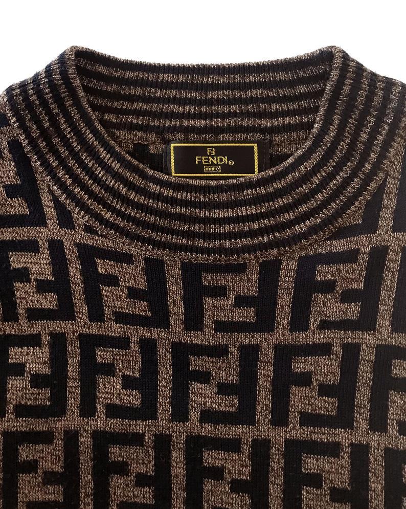 FRUIT vintage Fendi Zucca design sweater dating to the 1990s. This monogram knit features side splits and striped design on sleeves and neck. The logo is knitted into the jumper (intarsia style), the design is cut for a long-line, slightly oversized fit.