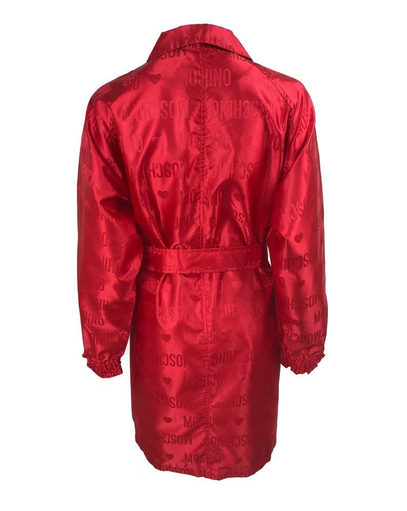 FRUIT Vintage red Moschino Cheap & Chic logo raincoat dating to the 1990s. It features large Moschino logo print all over, heart shaped button closure, front pockets and tie belt.