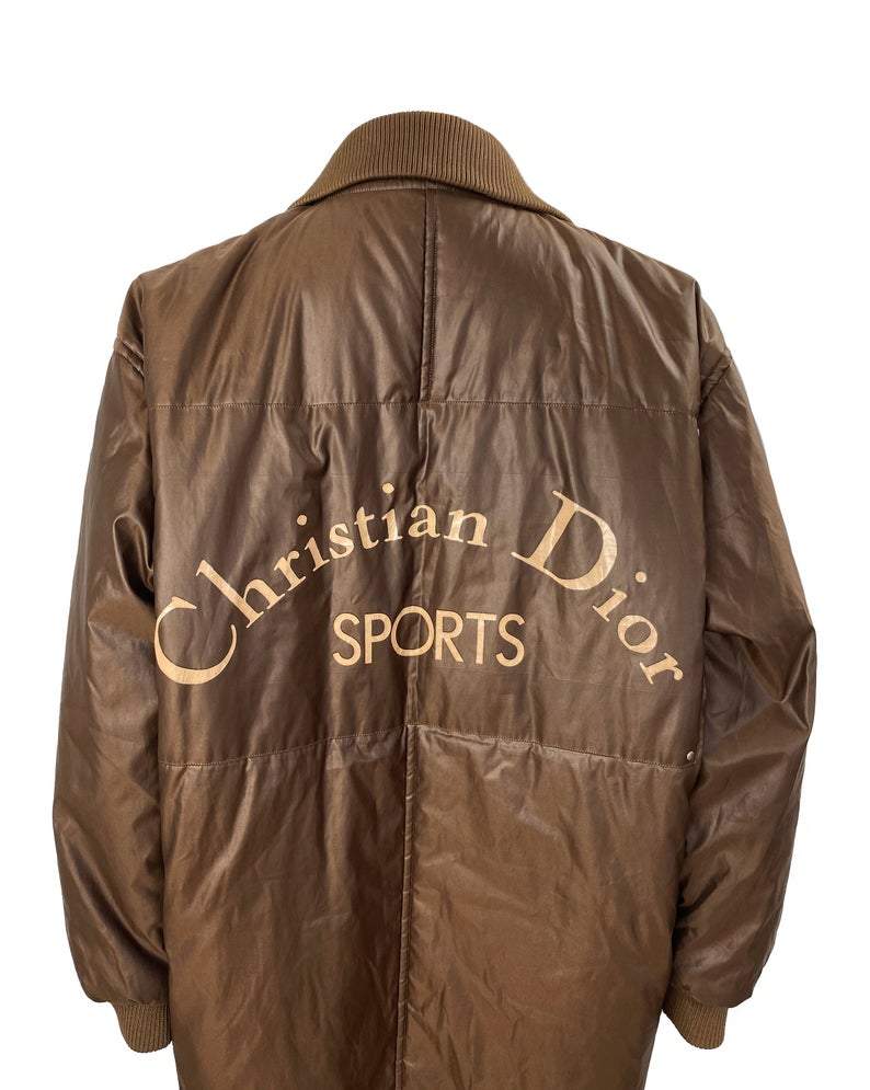 FRUIT vintage Christian Dior Sport Brown Logo puffer coat from the 1980s. It features a classic 1980s bomber style and large Christian Dior Sport text logo printed at rear.