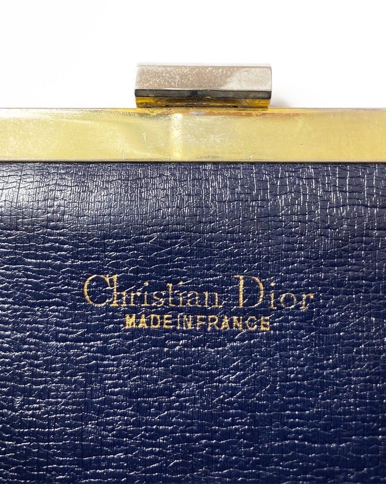 Fruit Vintage 1970s Christian Dior clutch bag with navy logo print canvas and featuring the iconic Dior 70's CD logo and gold hardware clip top closure