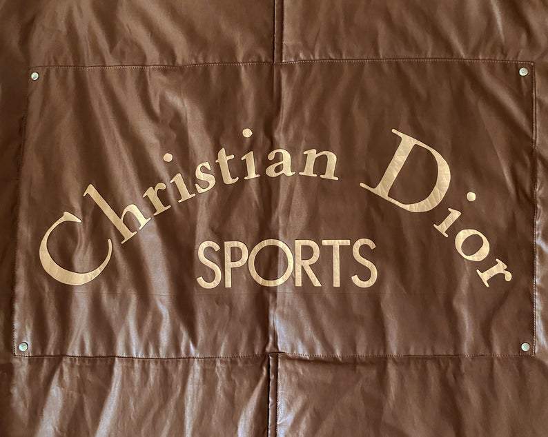 FRUIT vintage Christian Dior Sport Brown Logo puffer coat from the 1980s. It features a classic 1980s bomber style and large Christian Dior Sport text logo printed at rear.