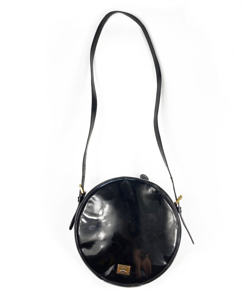 FRUIT Vintage rare Moschino Yin Yang Bag. Dating to the 1990s, the round purse has a large Yin Yang motif on the front made from appliquéd leather.