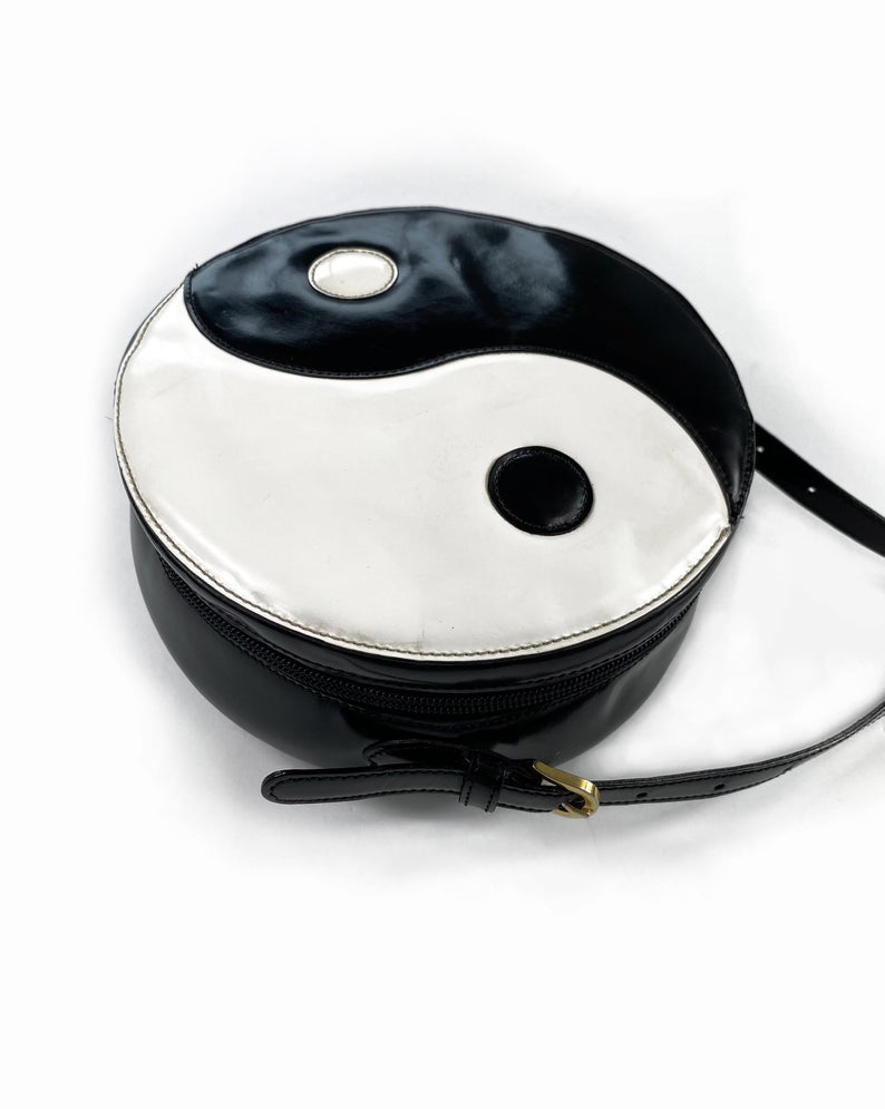 FRUIT Vintage rare Moschino Yin Yang Bag. Dating to the 1990s, the round purse has a large Yin Yang motif on the front made from appliquéd leather.