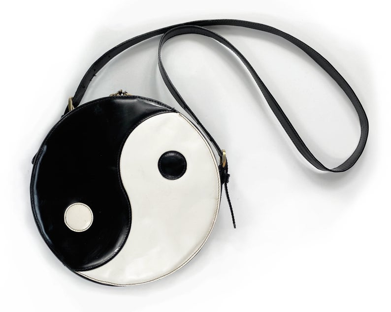 FRUIT Vintage rare Moschino Yin Yang Bag. Dating to the 1990s, the round purse has a large Yin Yang motif on the front made from appliquéd leather.