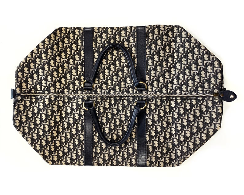 FRUIT vintage Christian Dior monogram logo trotter overnight travel bag dating to the 1980s. It features a classic duffel bag shape, dark navy leather trim and full cotton drill fabric lining.