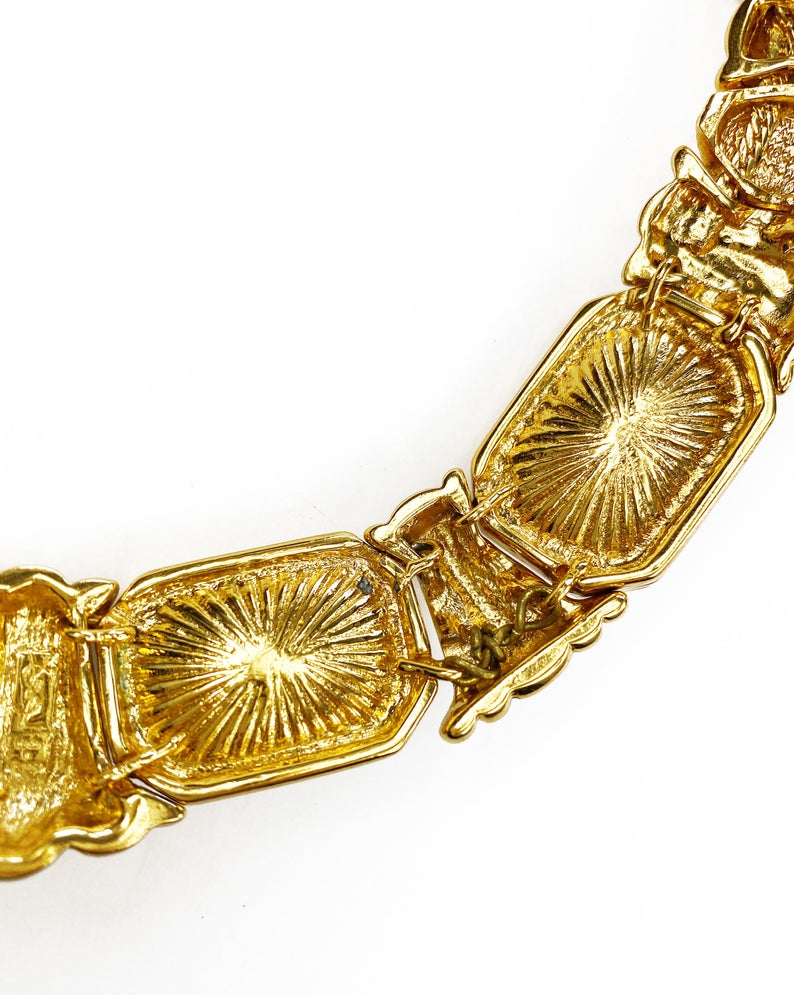 Fruit Vintage 1980s Yves Saint Laurent crystal collar choker necklace. It features 5 very large cut glass/crystals, heavy gold plating in a deep yellow tone and a reticulated moving design.