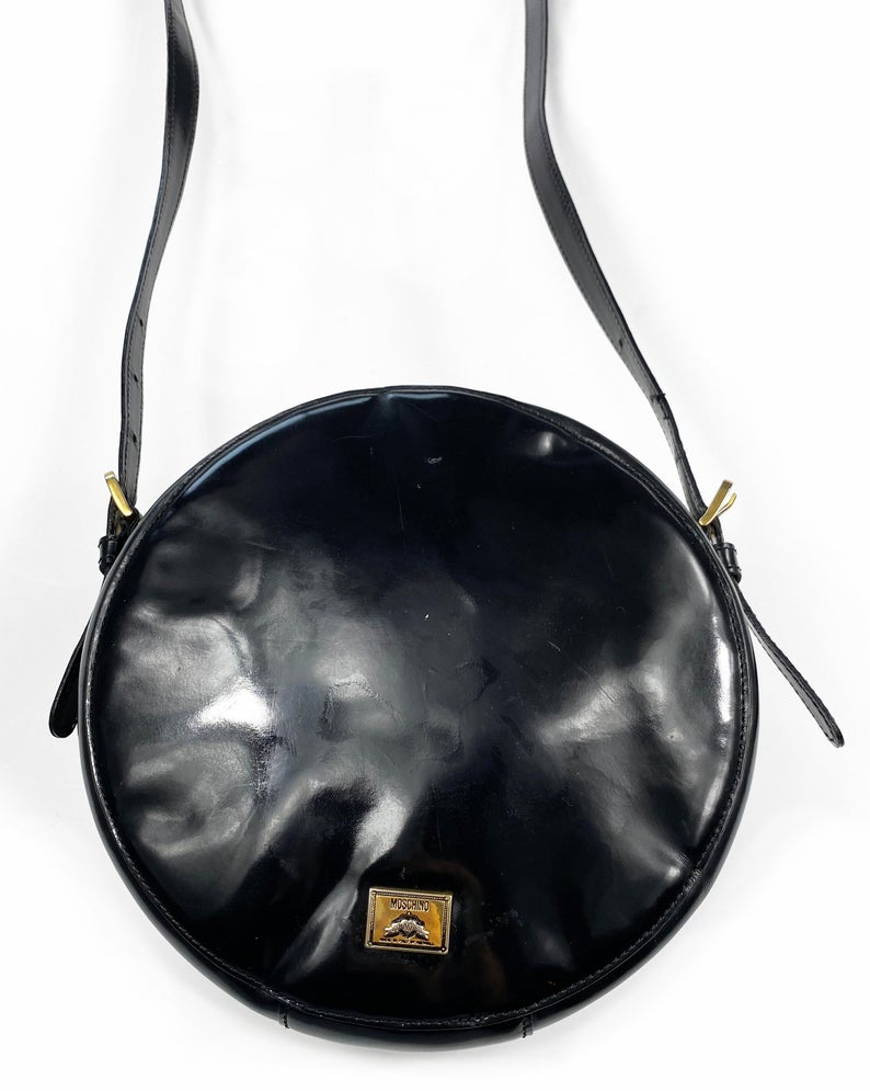 FRUIT Vintage rare Moschino Yin Yang Bag. Dating to the 1990s, the round purse has a large Yin Yang motif on the front made from appliquéd leather.