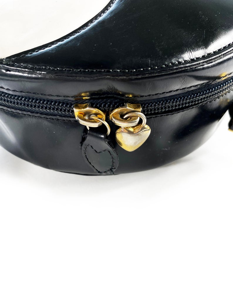 FRUIT Vintage rare Moschino Yin Yang Bag. Dating to the 1990s, the round purse has a large Yin Yang motif on the front made from appliquéd leather.