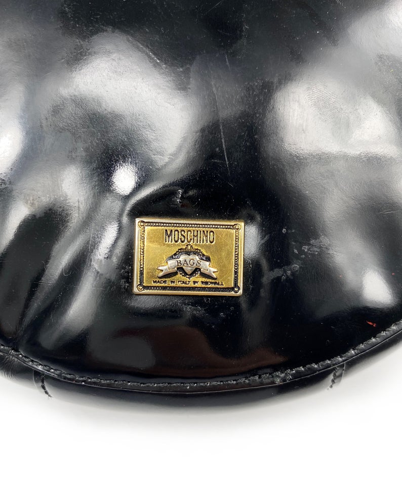 FRUIT Vintage rare Moschino Yin Yang Bag. Dating to the 1990s, the round purse has a large Yin Yang motif on the front made from appliquéd leather.