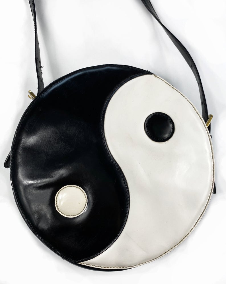 FRUIT Vintage rare Moschino Yin Yang Bag. Dating to the 1990s, the round purse has a large Yin Yang motif on the front made from appliquéd leather.