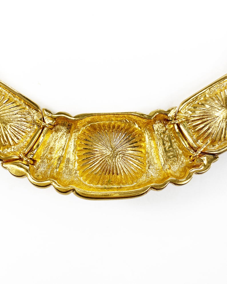 Fruit Vintage 1980s Yves Saint Laurent crystal collar choker necklace. It features 5 very large cut glass/crystals, heavy gold plating in a deep yellow tone and a reticulated moving design.