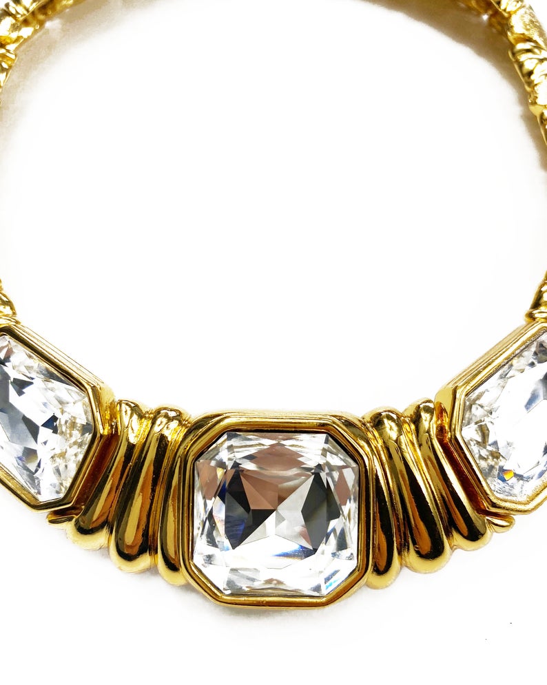 Fruit Vintage 1980s Yves Saint Laurent crystal collar choker necklace. It features 5 very large cut glass/crystals, heavy gold plating in a deep yellow tone and a reticulated moving design.