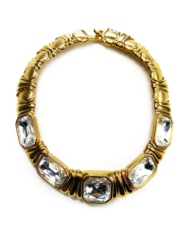Fruit Vintage 1980s Yves Saint Laurent crystal collar choker necklace. It features 5 very large cut glass/crystals, heavy gold plating in a deep yellow tone and a reticulated moving design.