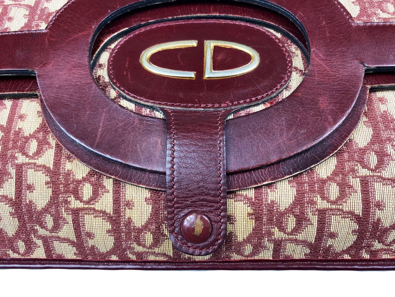 FRUIT vintage 1970s Christian Dior convertible monogram clutch/tote bag as worn by Carrie in Sex and City, it features a Christian Dior 1970s logo at front with snap closure for when it is folded to become a clutch, classic oblique trotter canvas and leather handles.