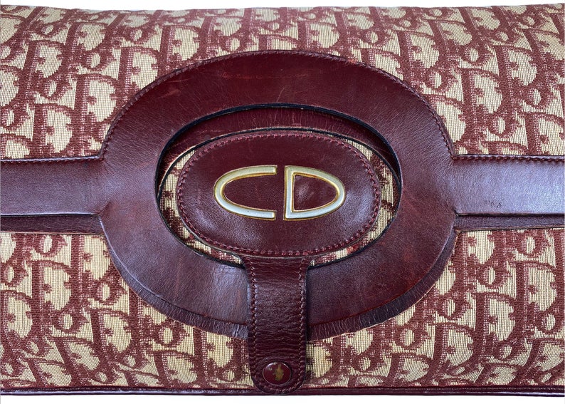 FRUIT vintage 1970s Christian Dior convertible monogram clutch/tote bag as worn by Carrie in Sex and City, it features a Christian Dior 1970s logo at front with snap closure for when it is folded to become a clutch, classic oblique trotter canvas and leather handles.