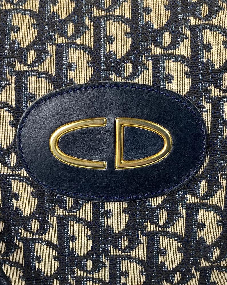 FRUIT Vintage 1970s Christian Dior navy monogram trotter oblique bowling bag. It features a large CD logo to the front, leather trim, 2 internal logo pockets and logo zipper pull.