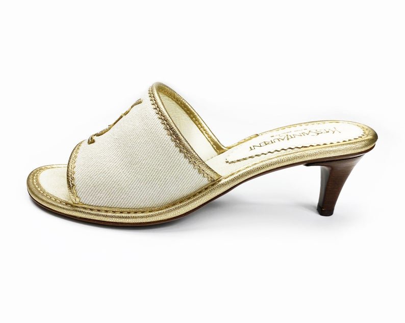 FRUIT Vintage Yves Saint Laurent logo canvas mules with gold leather trim. Features a a large gold leather YSL logo at front and stacked wooden heels.