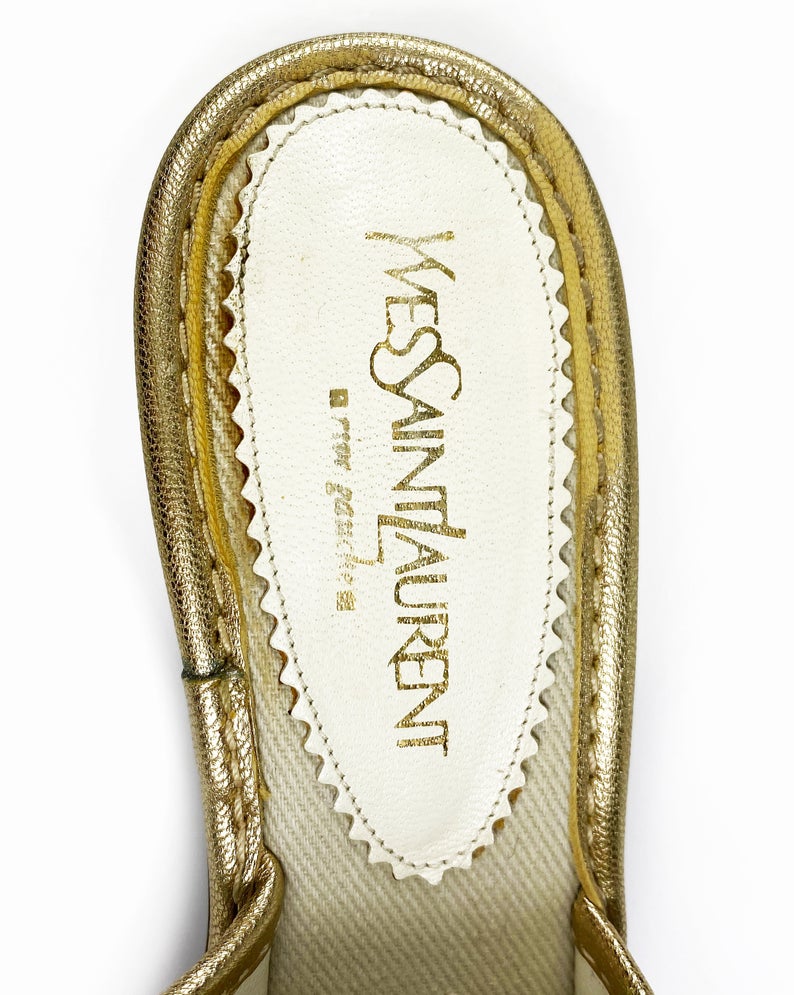 FRUIT Vintage Yves Saint Laurent logo canvas mules with gold leather trim. Features a a large gold leather YSL logo at front and stacked wooden heels.