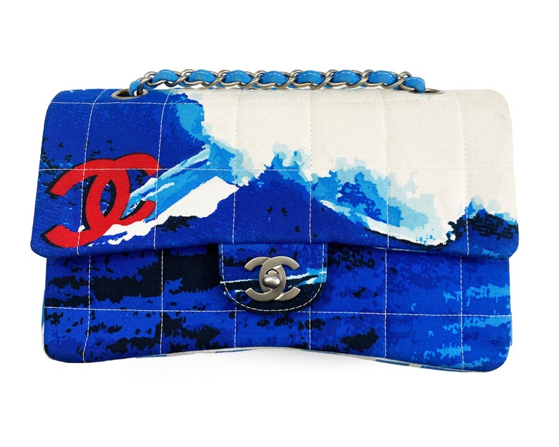 Fruit Vintage Chanel quilted surf print logo canvas flap bag. Features a graphic blue and white surf/wave print on canvas, a square quilted stitching design, classic Chanel flap and zipper closure with Chanel logo pull.