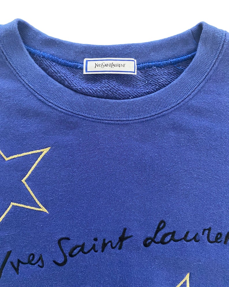 FRUIT Vintage Yves Saint Laurent logo star embroidered blue sweatshirt. Features a large text YSL logo at front and a classic 90's cut.