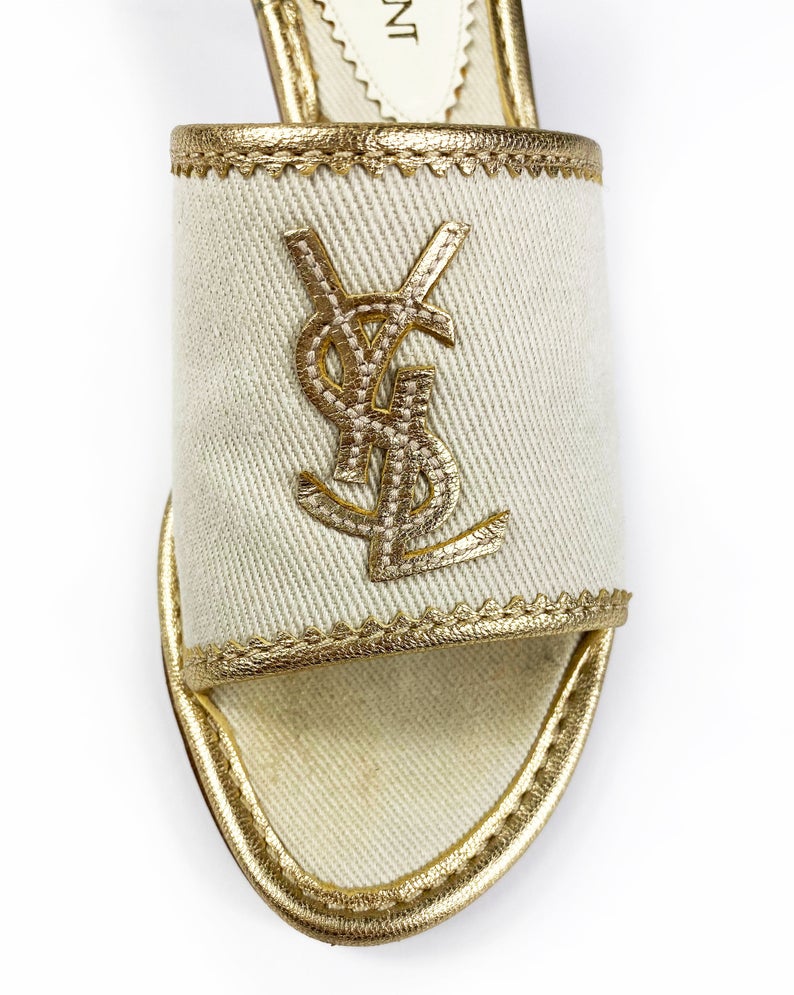 FRUIT Vintage Yves Saint Laurent logo canvas mules with gold leather trim. Features a a large gold leather YSL logo at front and stacked wooden heels.