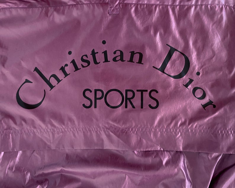 FRUIT Vintage rare Purple Christian Dior Sport Logo bomber jacket from the 1980s. It features a classic 1980s bomber jacket cut with over flap and large Christian Dior Sport text logo printed at rear.