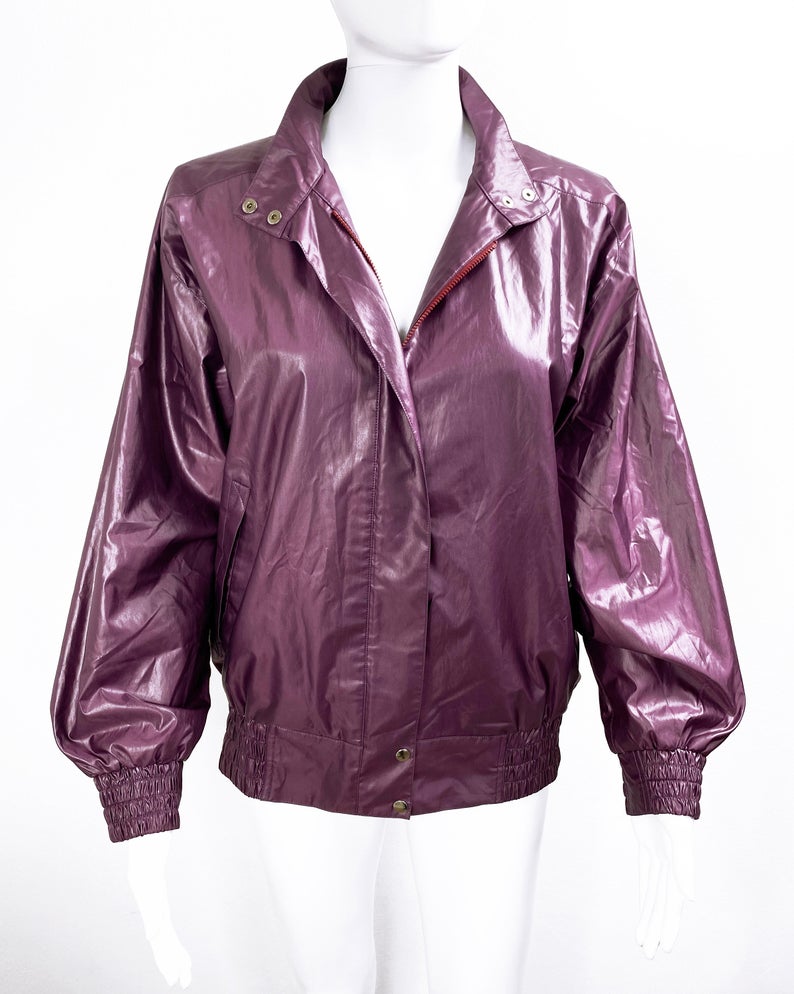 FRUIT Vintage rare Purple Christian Dior Sport Logo bomber jacket from the 1980s. It features a classic 1980s bomber jacket cut with over flap and large Christian Dior Sport text logo printed at rear.